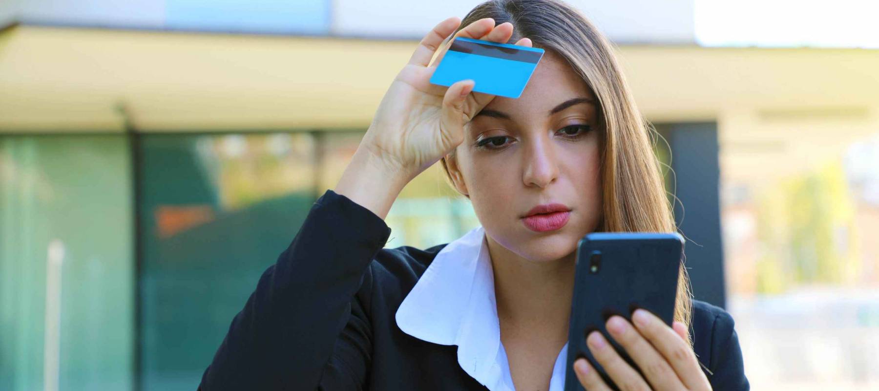 Covid-19 Economic Crisis Coronavirus Pandmeic. Desperate business woman looking on mobile phone her credit card statement stressed. Global economic crisis.