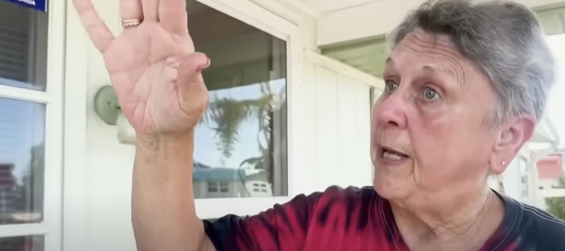 A woman speaks to a reporter on camera.