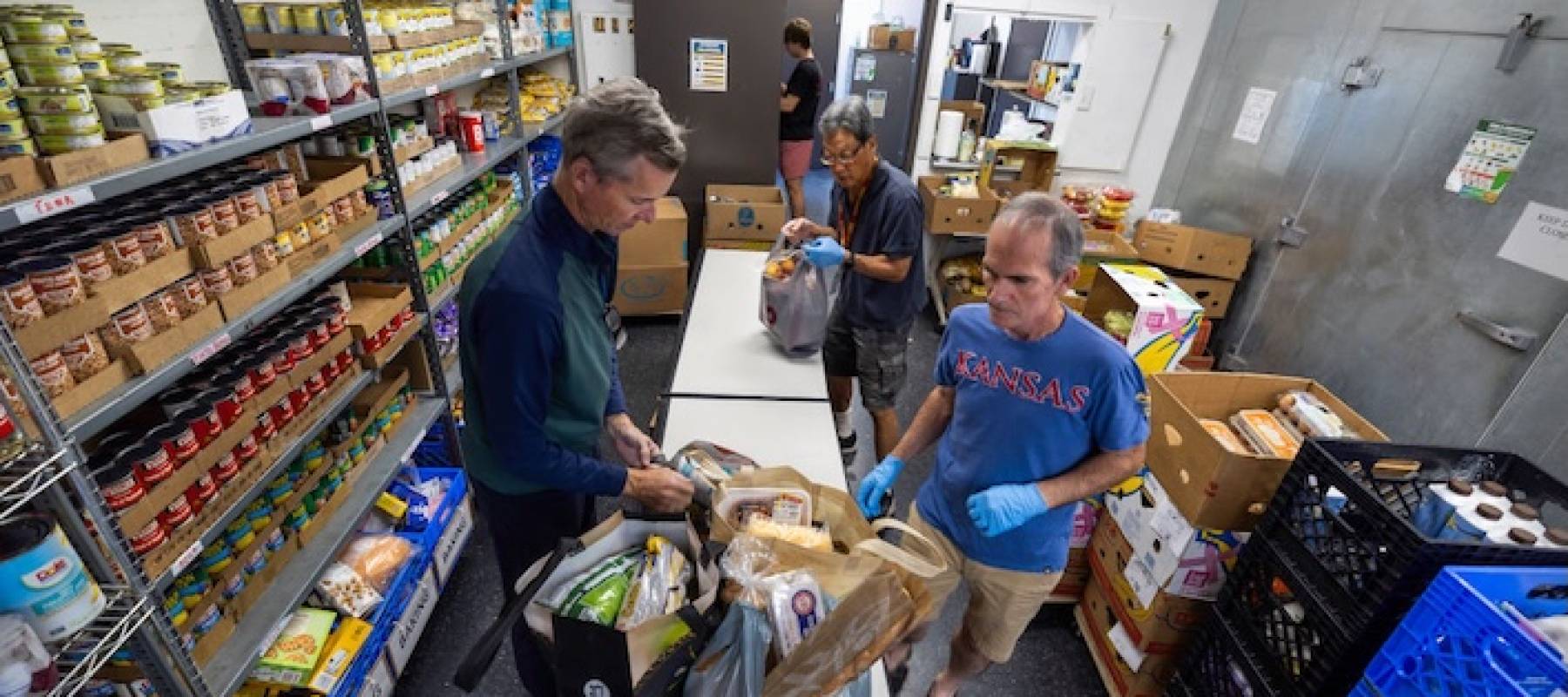 Men in a food stock room