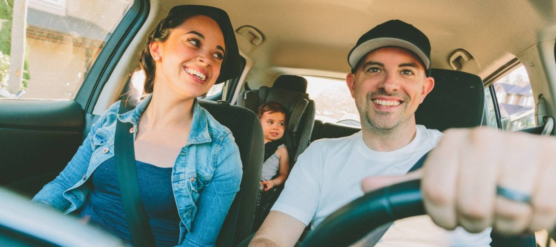family in car with kid
