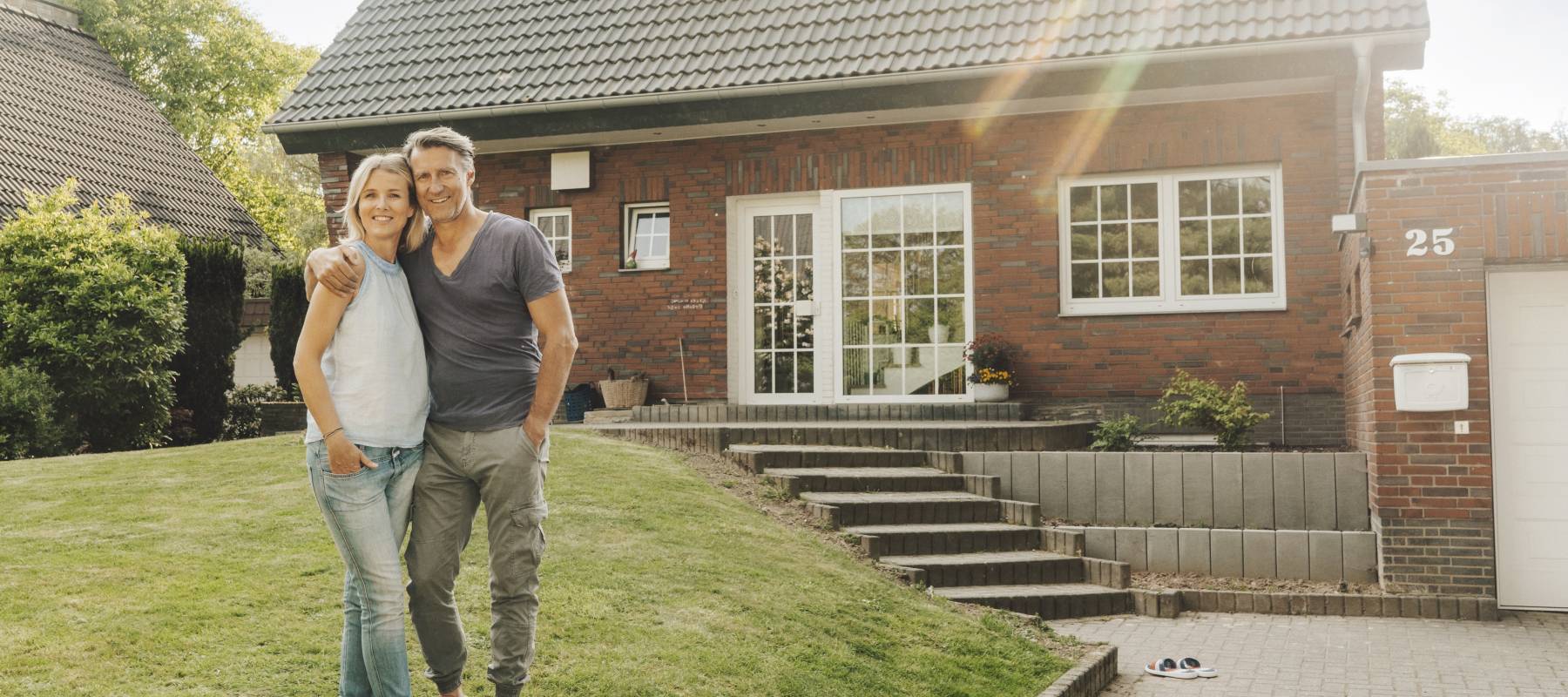 A couple outside of their home.