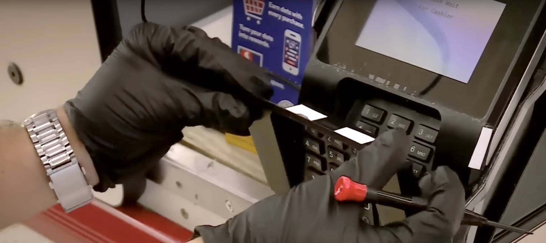 An agent uncovers a skimming device at a Memphis grocery store.