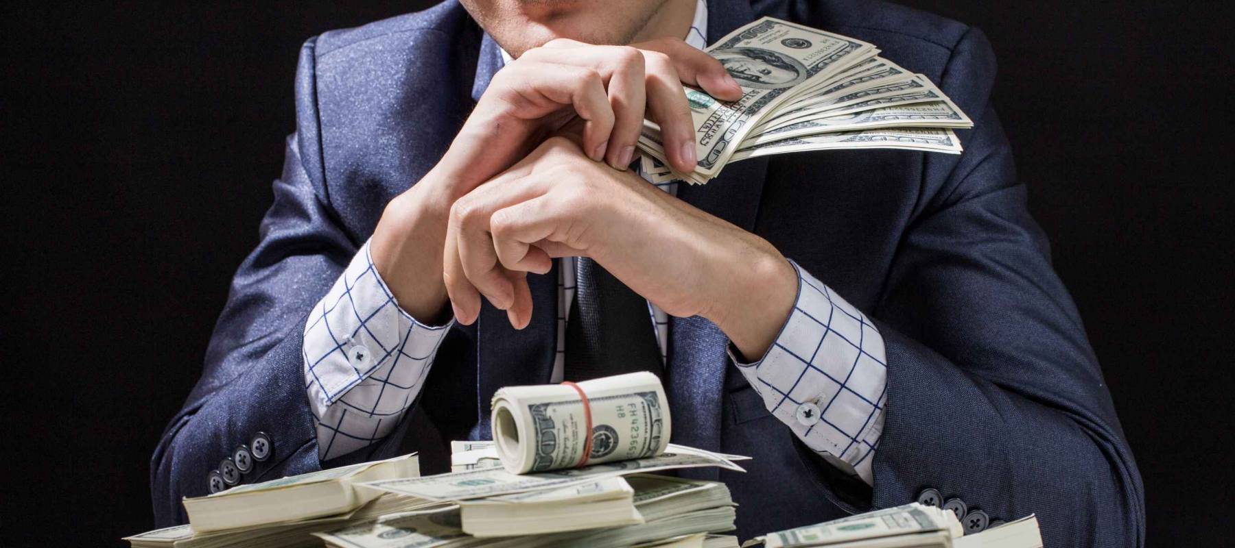 Man holding Money in hand in Black Background