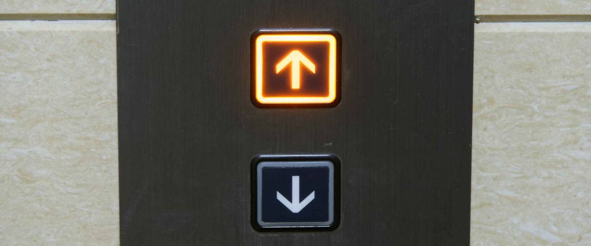 Up and down elevator buttons with up-button lighten up