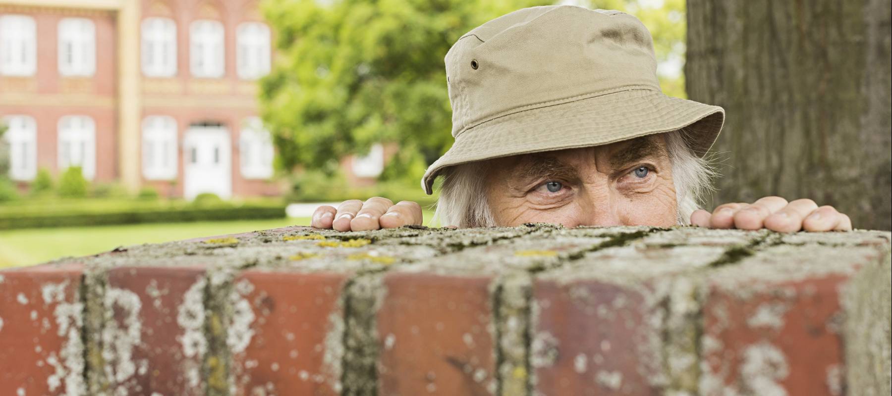 Man standing beside fence