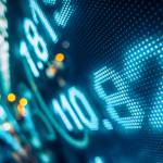Financial stock market numbers and city light reflection