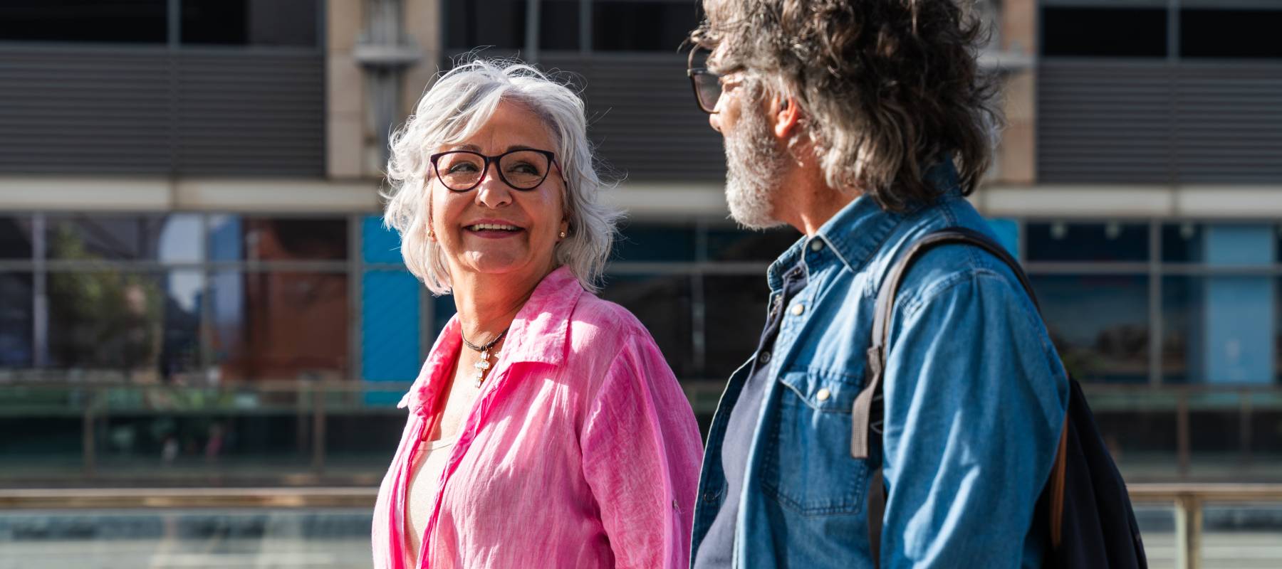 Happy senior couple bonding outdoors in a cityscape.