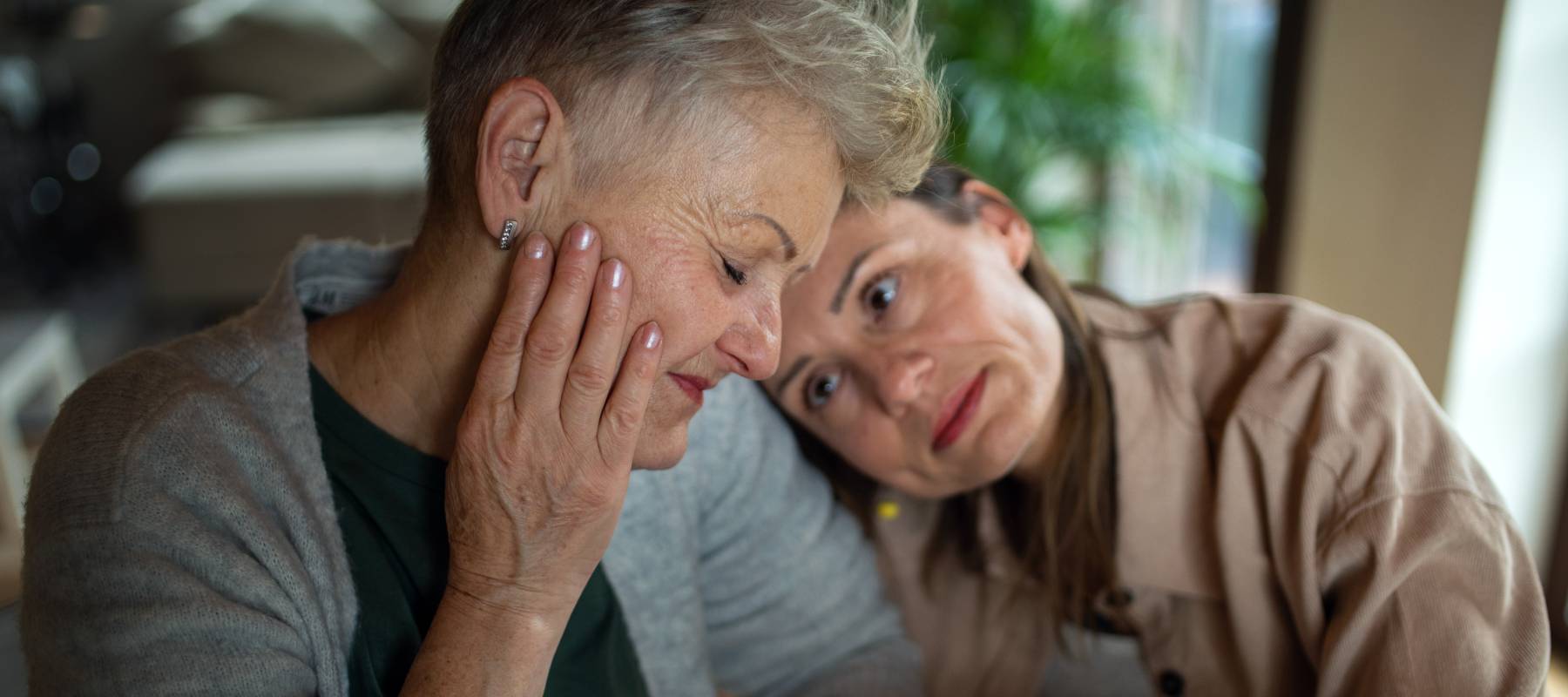 A mother and daughter embrace.