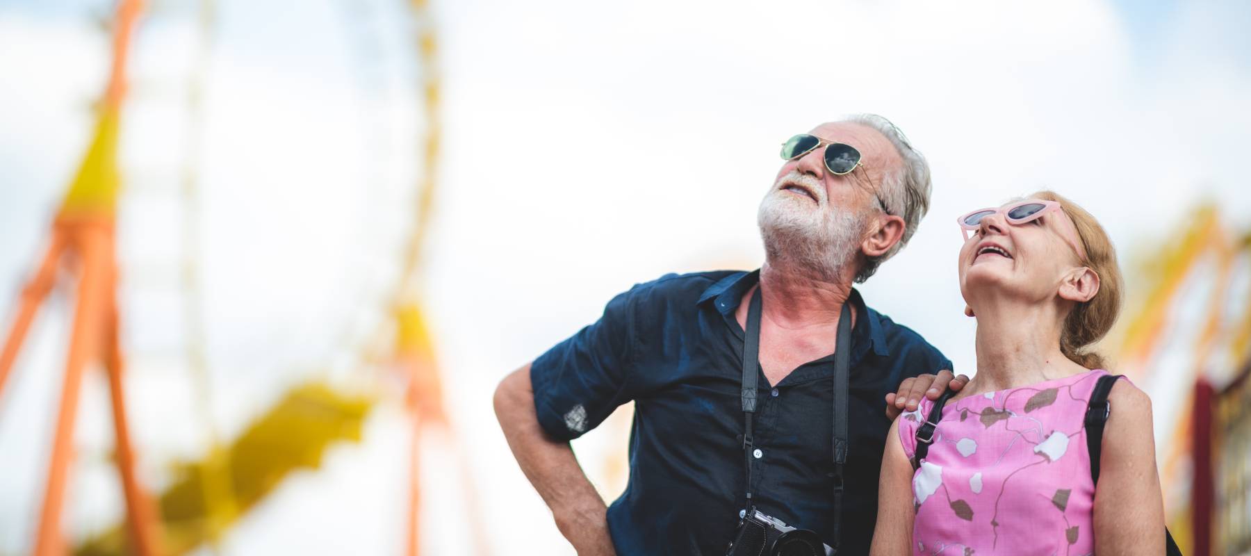 An older couple at an amusement park.