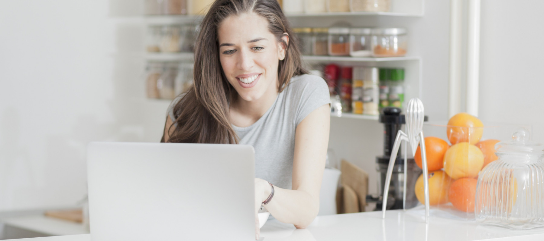 Young woman looking for a recipe on her computer