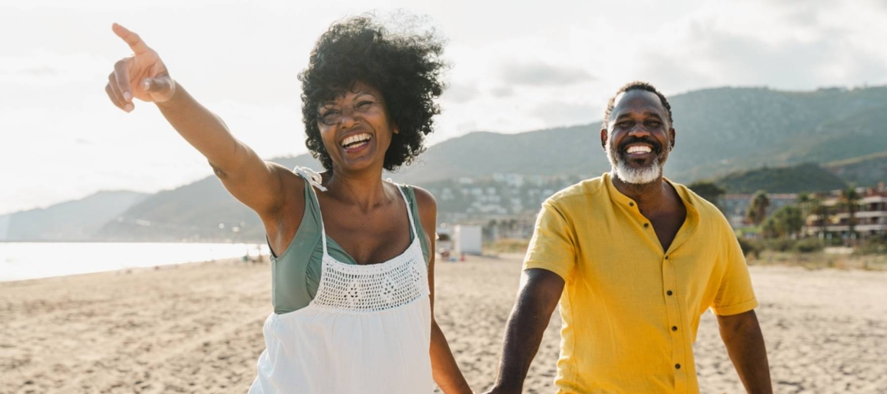 Married African-American middle-aged couple bonding and having fun outdoors