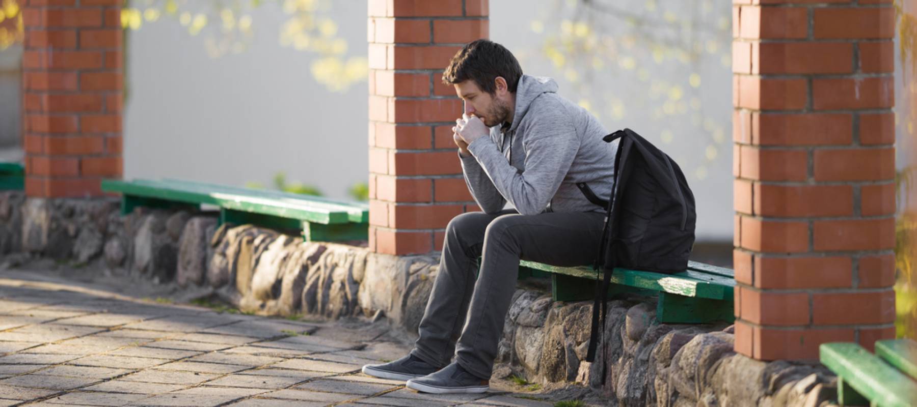 Pensive student on bench.