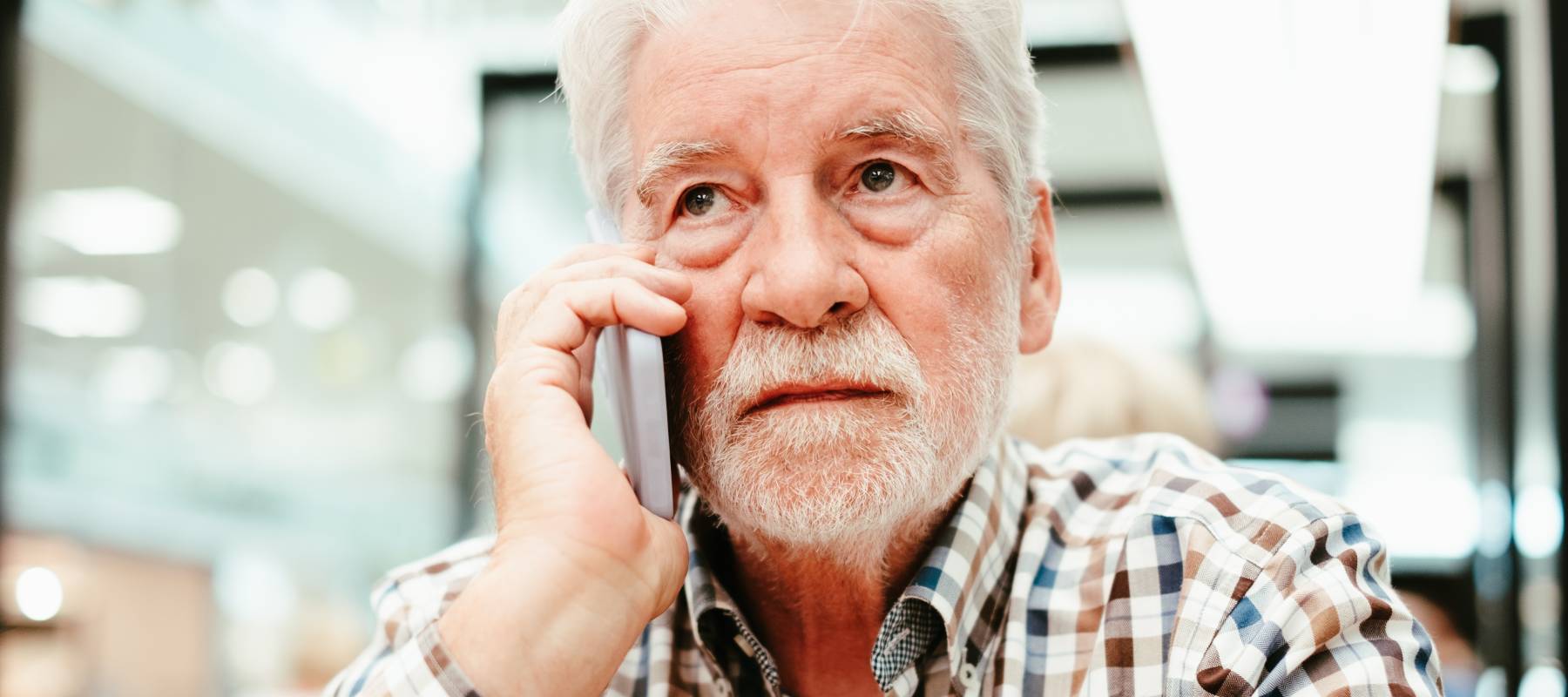 serious Caucasian senior man on his cellphone