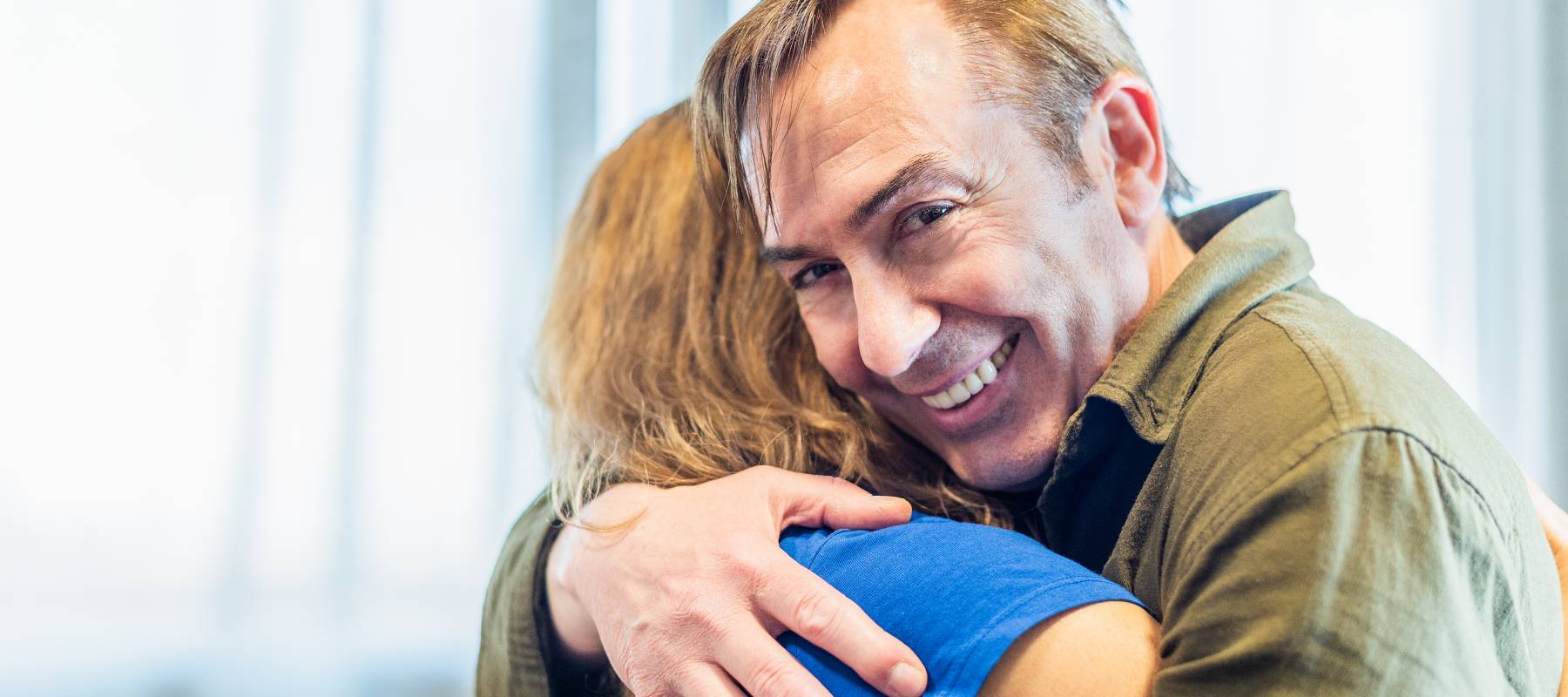 A man and woman hugging.