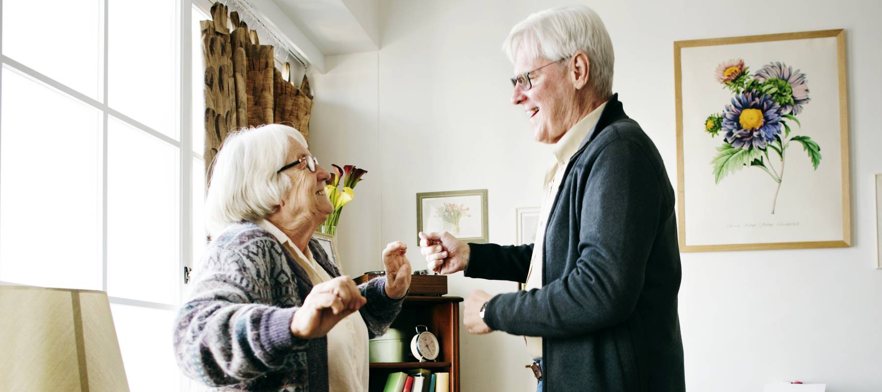 An older couple dances together.