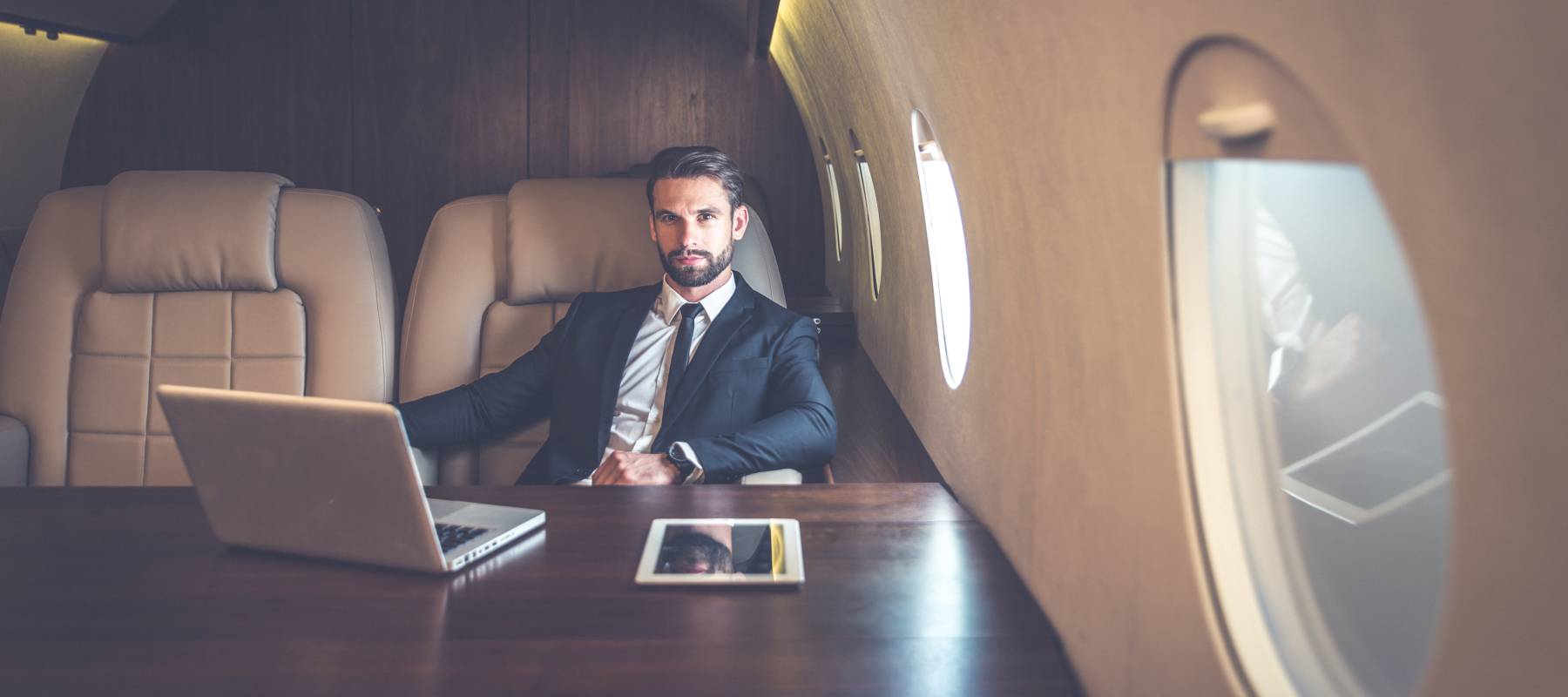 Caucasian man stands on the balcony of the hotel and looks at the mountains and the sea
