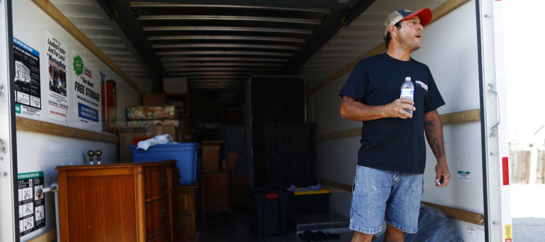 Johnnie Jackson stands in a U-Haul truck with items removed from the Eldridge family home