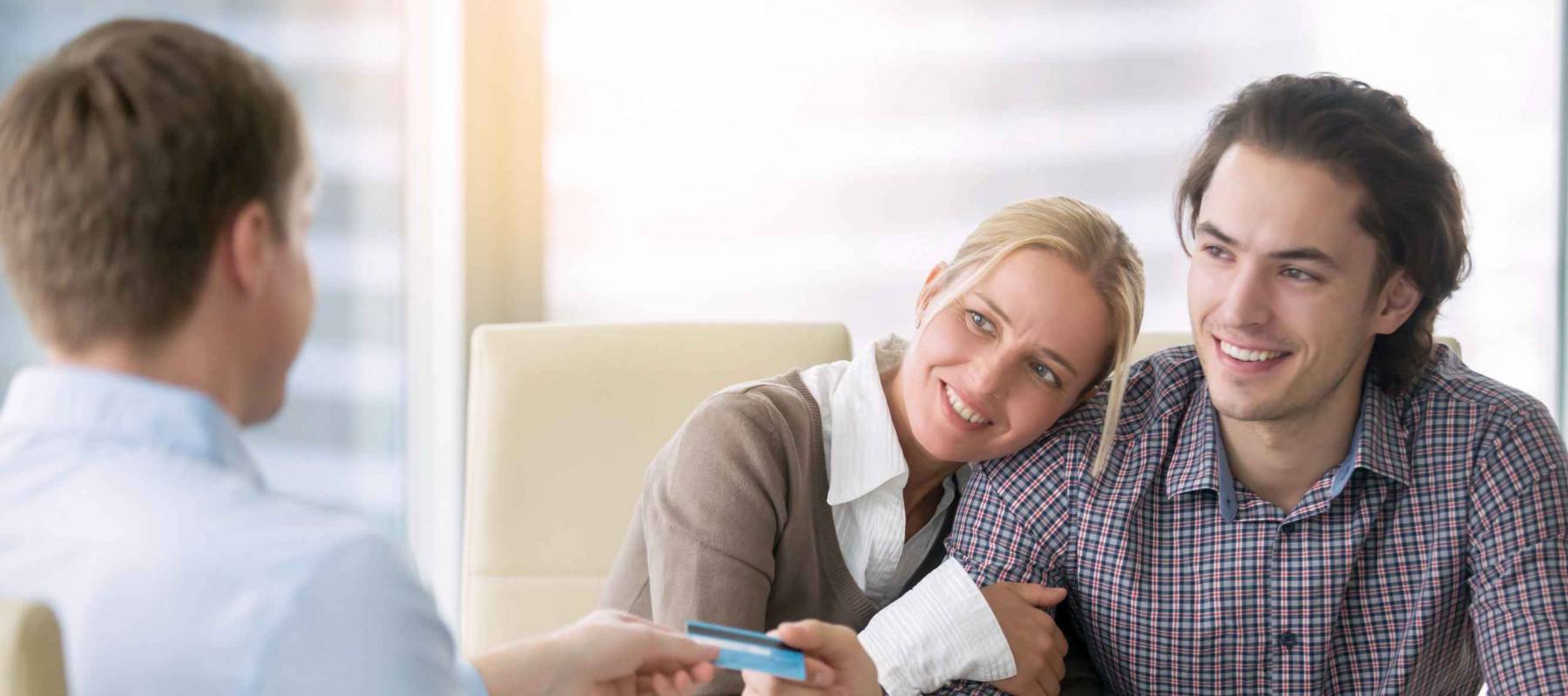 Young happy couple getting a loan concept, first time home buyers, tenancy agreement, agency as a broker between the landlord and tenant, signed all paper and paying with credit card