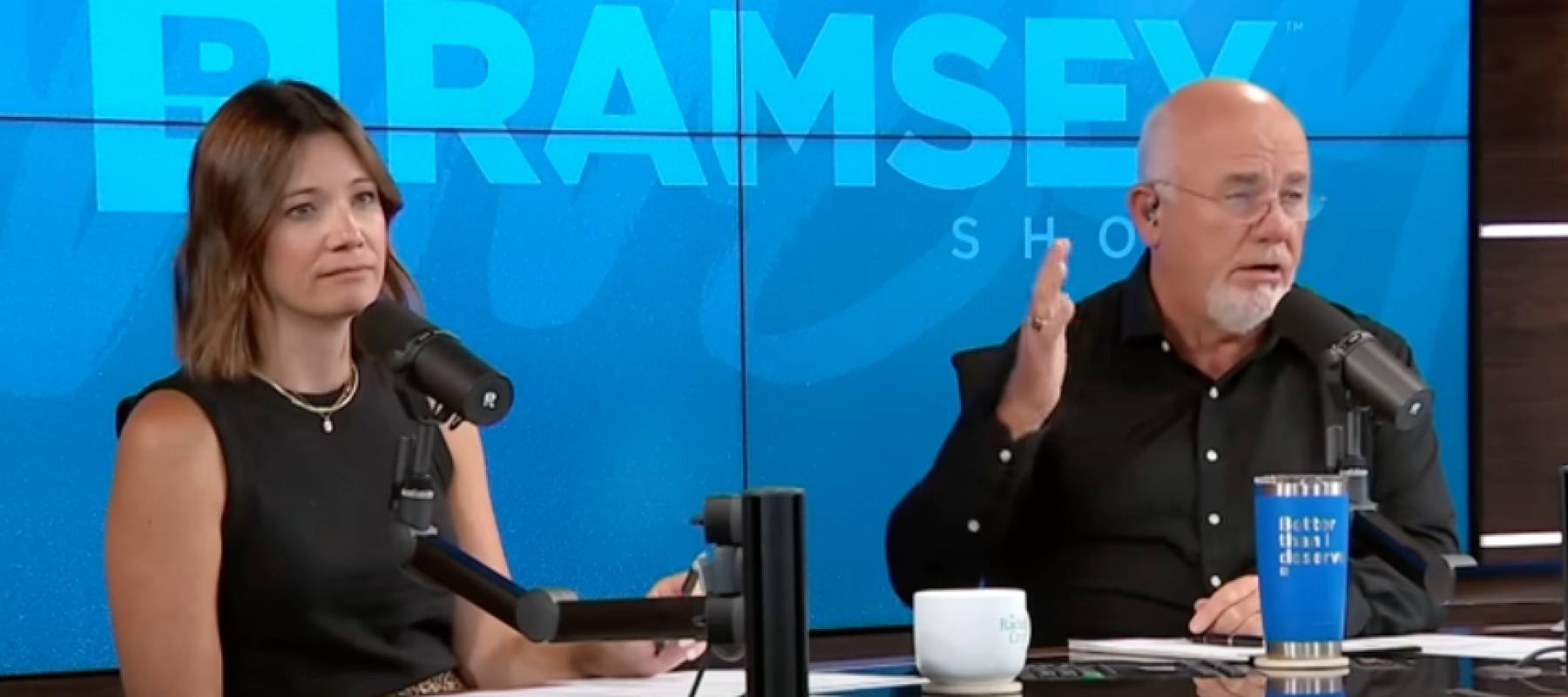 The Ramsey Show hosts listen to a caller on camera.