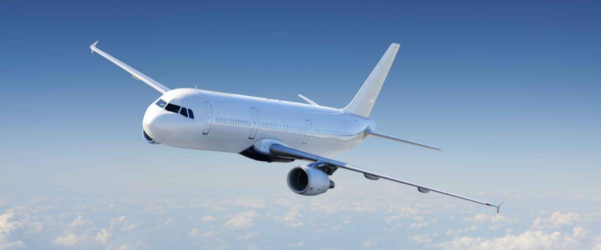 Big Passenger airplane flying over cloudy sky