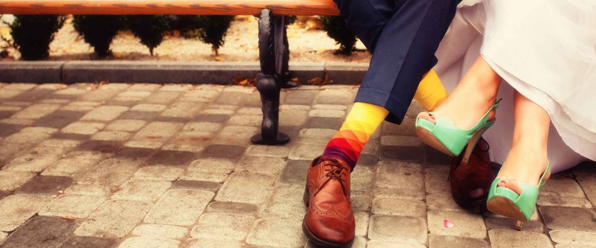Bride and groom in bright clothes on the bench