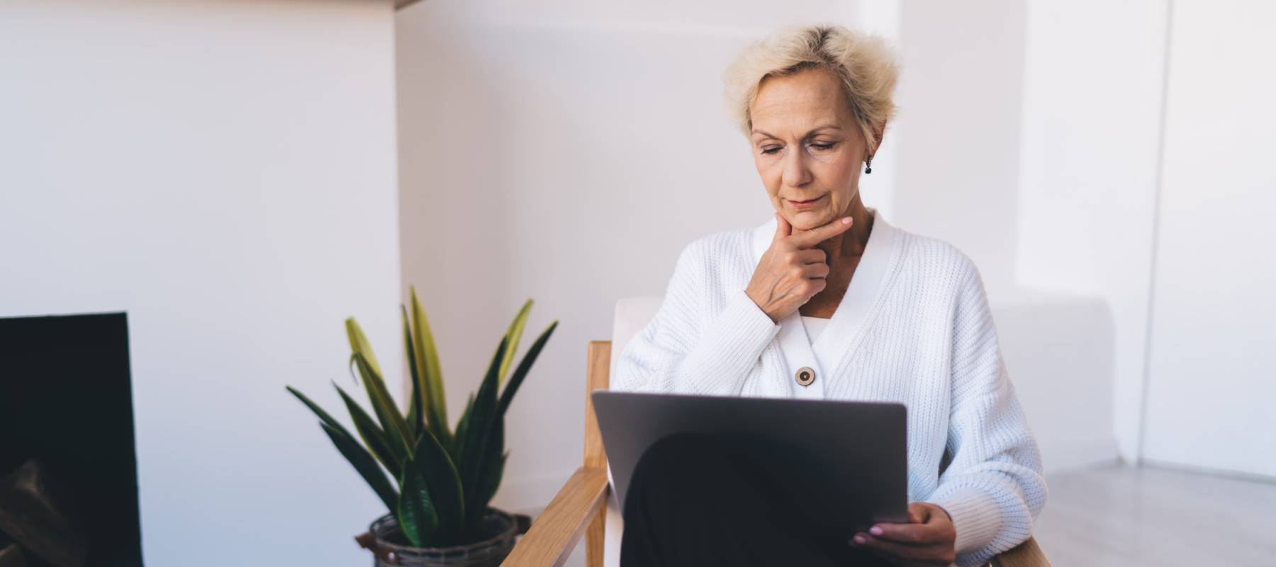 middle-aged Caucasian female freelancer with computer in living room