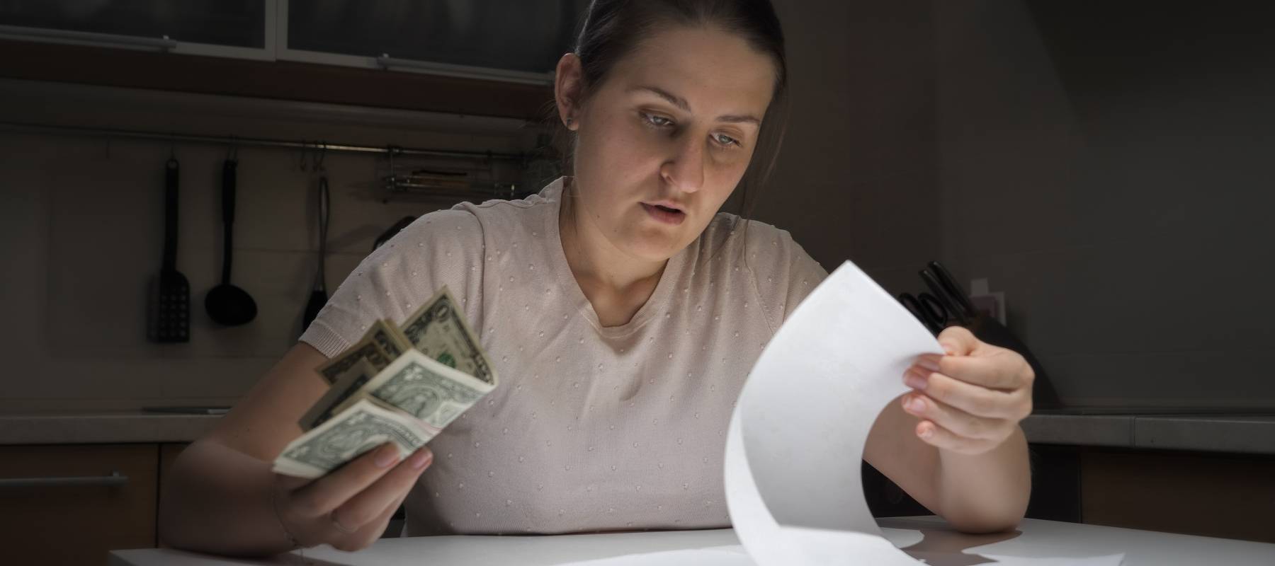 Stressed woman with bills.
