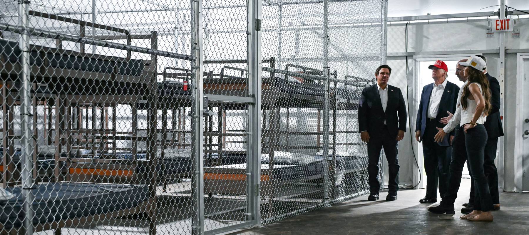 US President President Donald Trump (2L), Florida Governor Ron DeSantis (L), and Secretary of Homeland Security Kristi Noem (R) tour a migrant detention center, dubbed "Alligator Alcatraz.