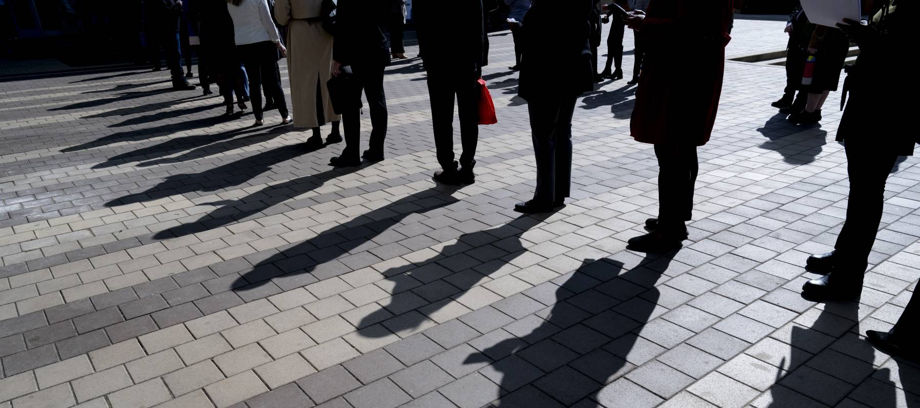 Job seekers wait in line to enter a job fair event in Silver Spring, Maryland.