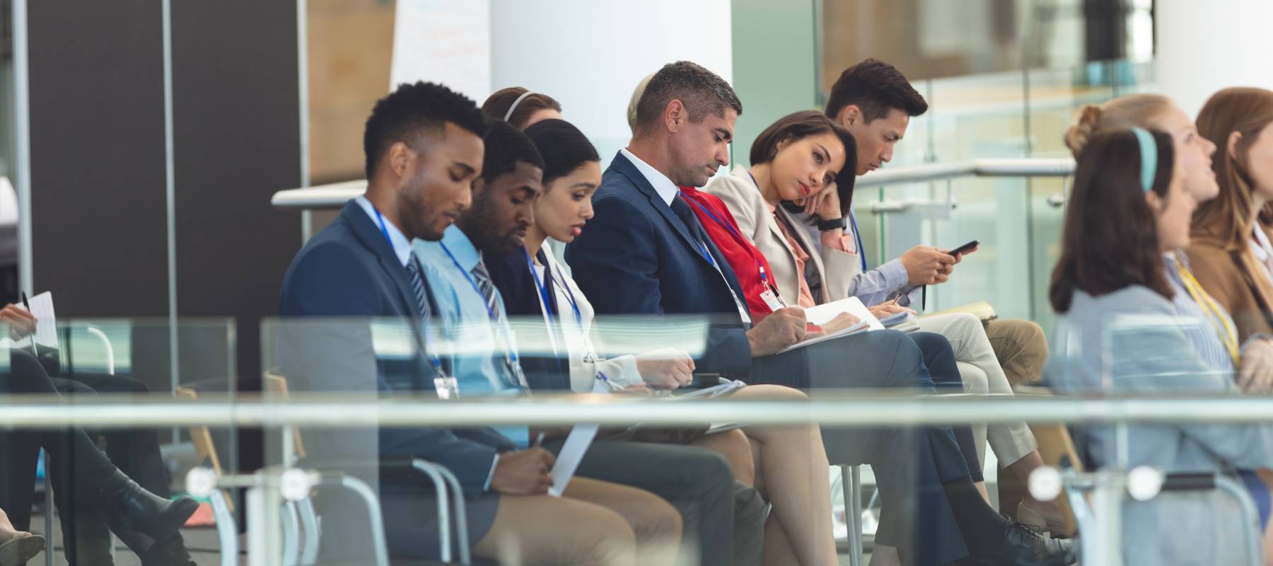 A group of business people sitting in a lobby.