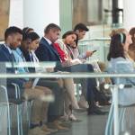 A group of business people sitting in a lobby.