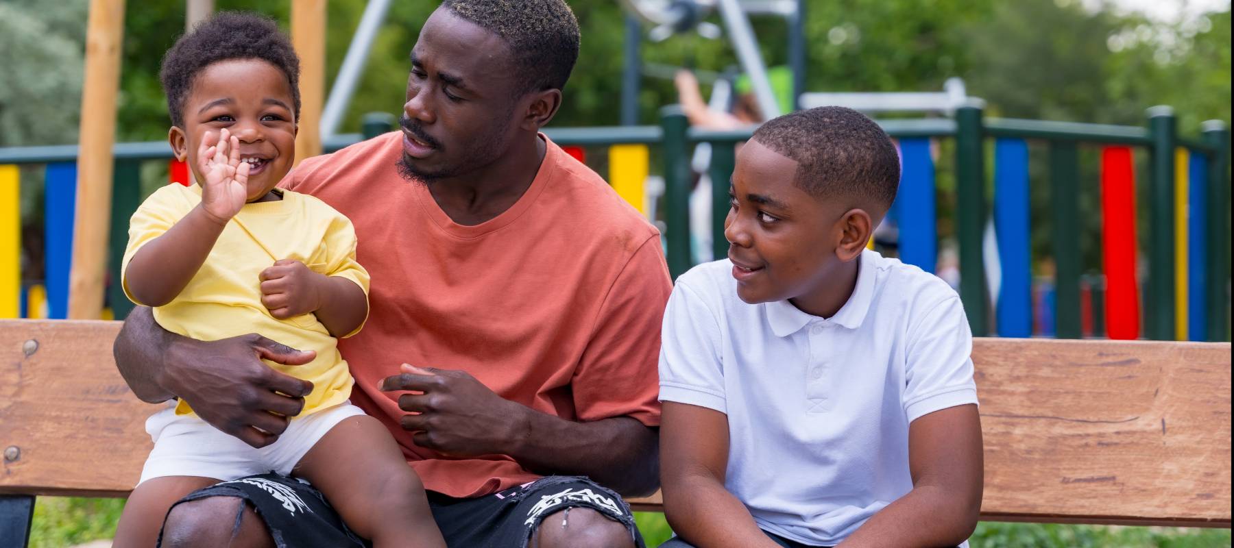 Dad with two kids at playground.