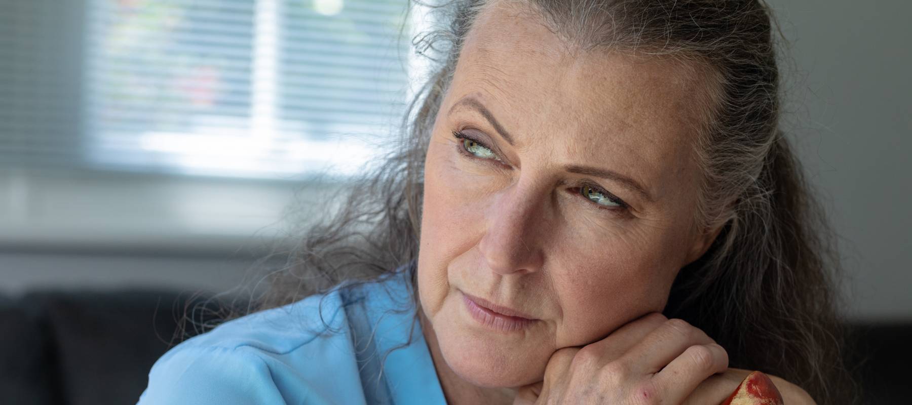 Senior woman staring into distance.