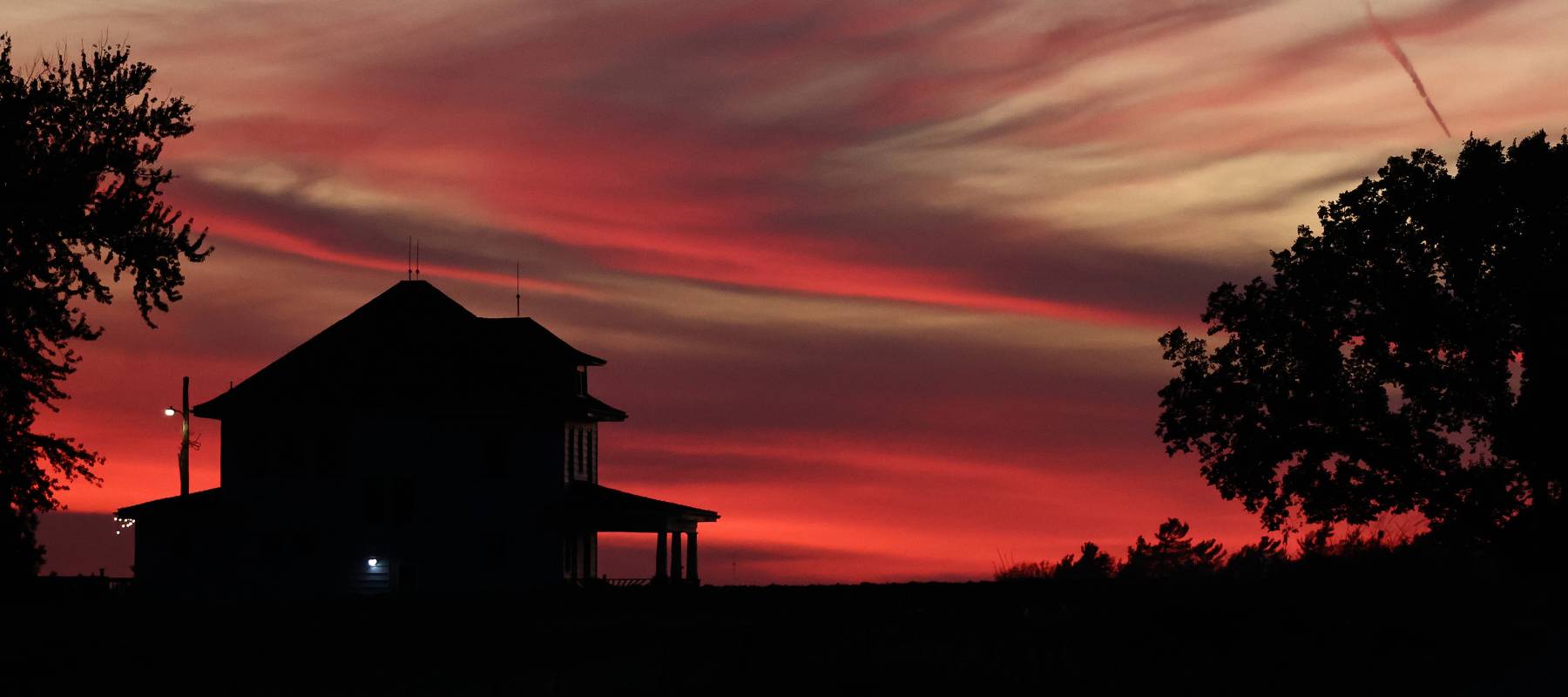 A farmhouse stands at dusk in Cedar Bluffs, Nebraska, Oct. 23, 2024.