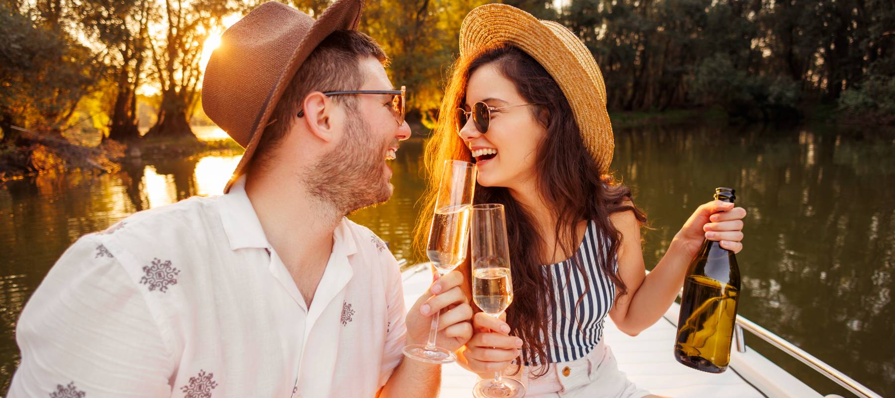 Couple toast while on a boat.