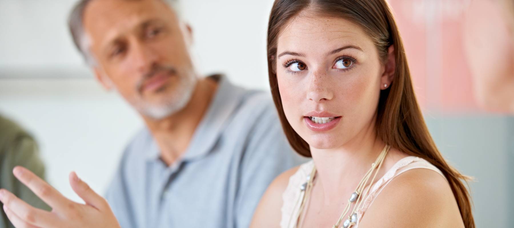 A young woman holds court in a discussion.