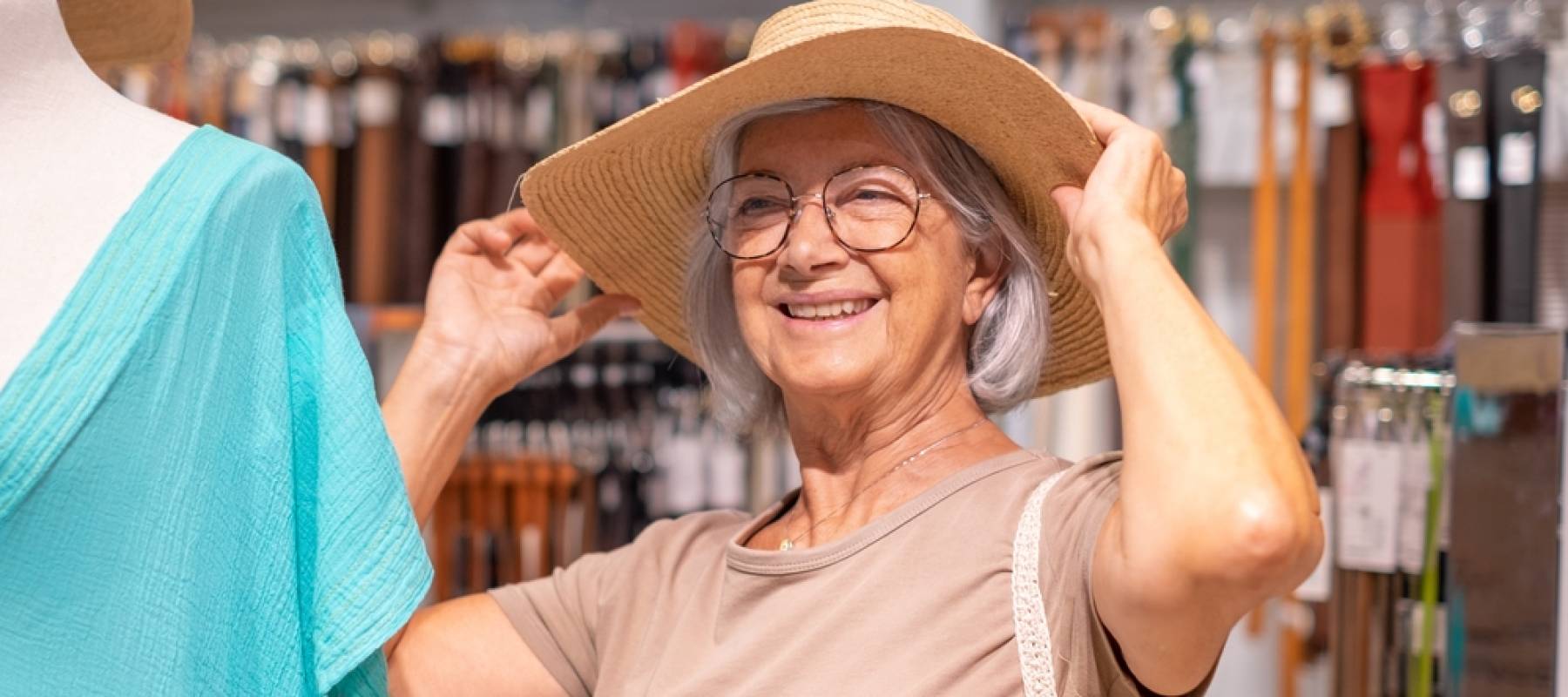 an older Caucasian woman trying on hats in a clothing store