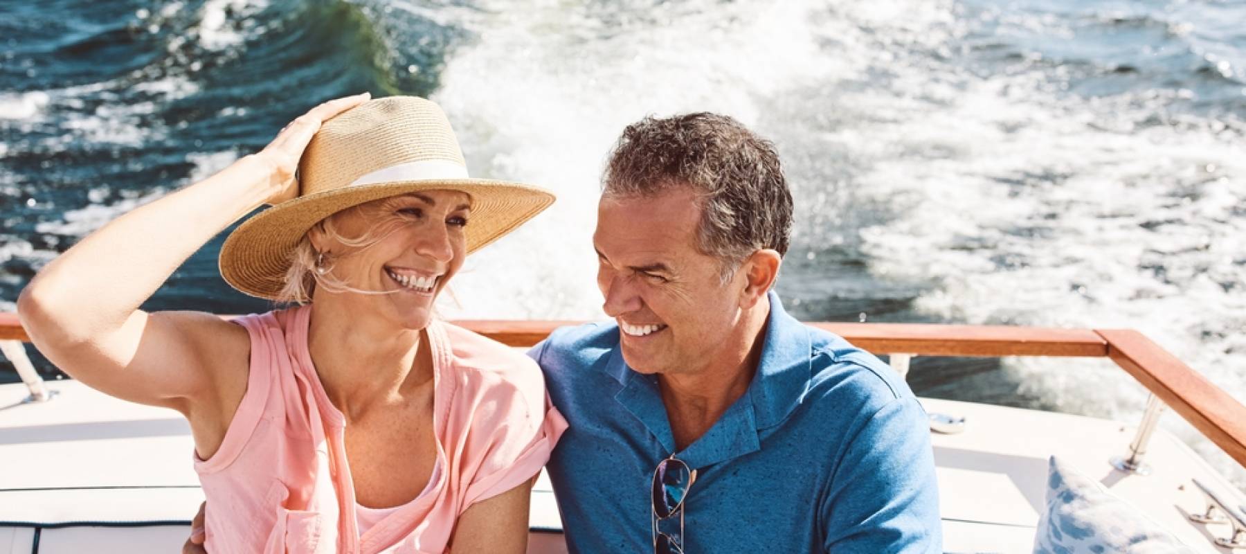 a happy Caucasian senior couple on a speedboat