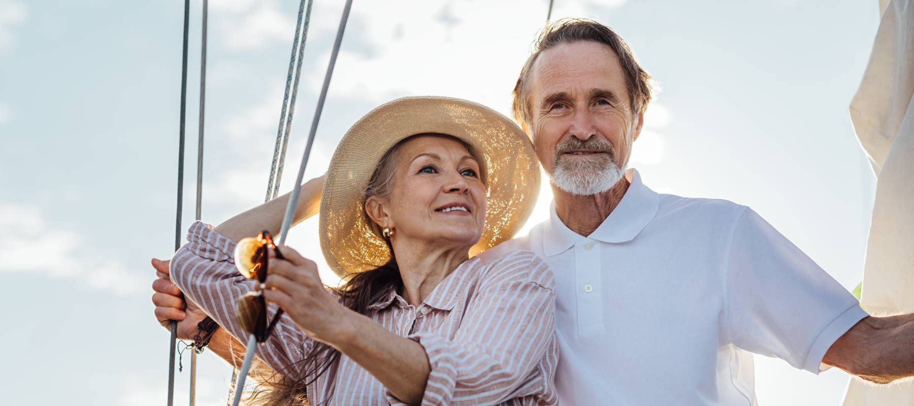 mature Caucasian couple standing on a yacht