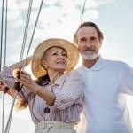 mature Caucasian couple standing on a yacht