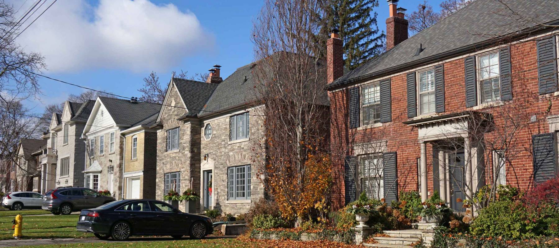 front yards and driveways of street with suburban houses