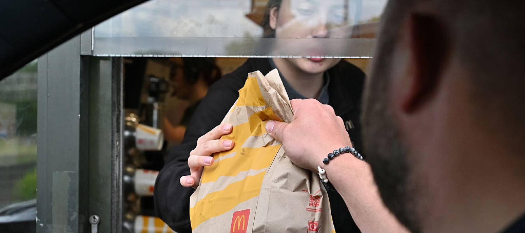 A driver picks up a McDonald's meal.