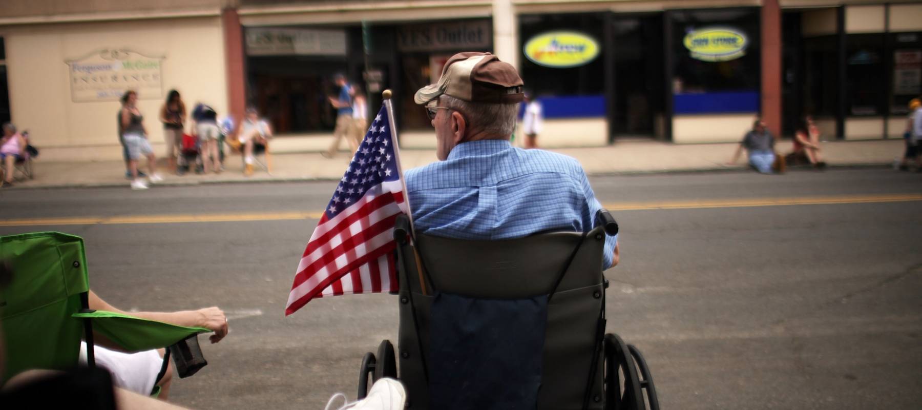 People wait for the start of the Memorial Day Parade in Ansonia, Connecticut, May 29, 2011.