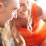 family, transport, safety, road trip and people concept - happy parents talking to little girl in baby car seat