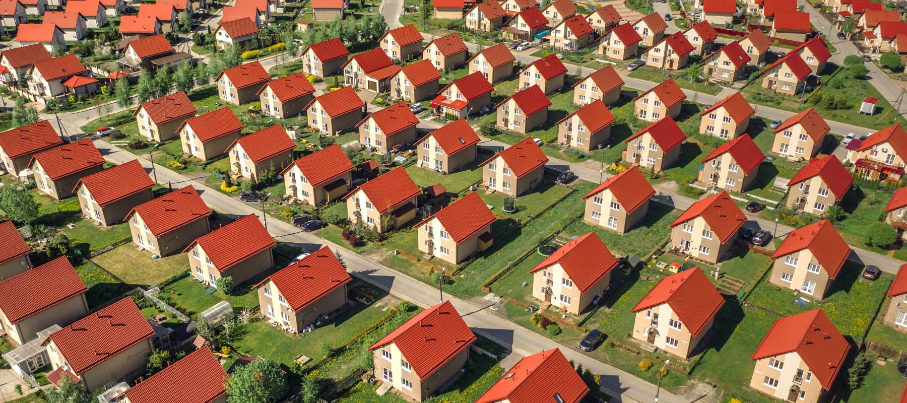 Aerial view of rows of dozens of identical houses.
