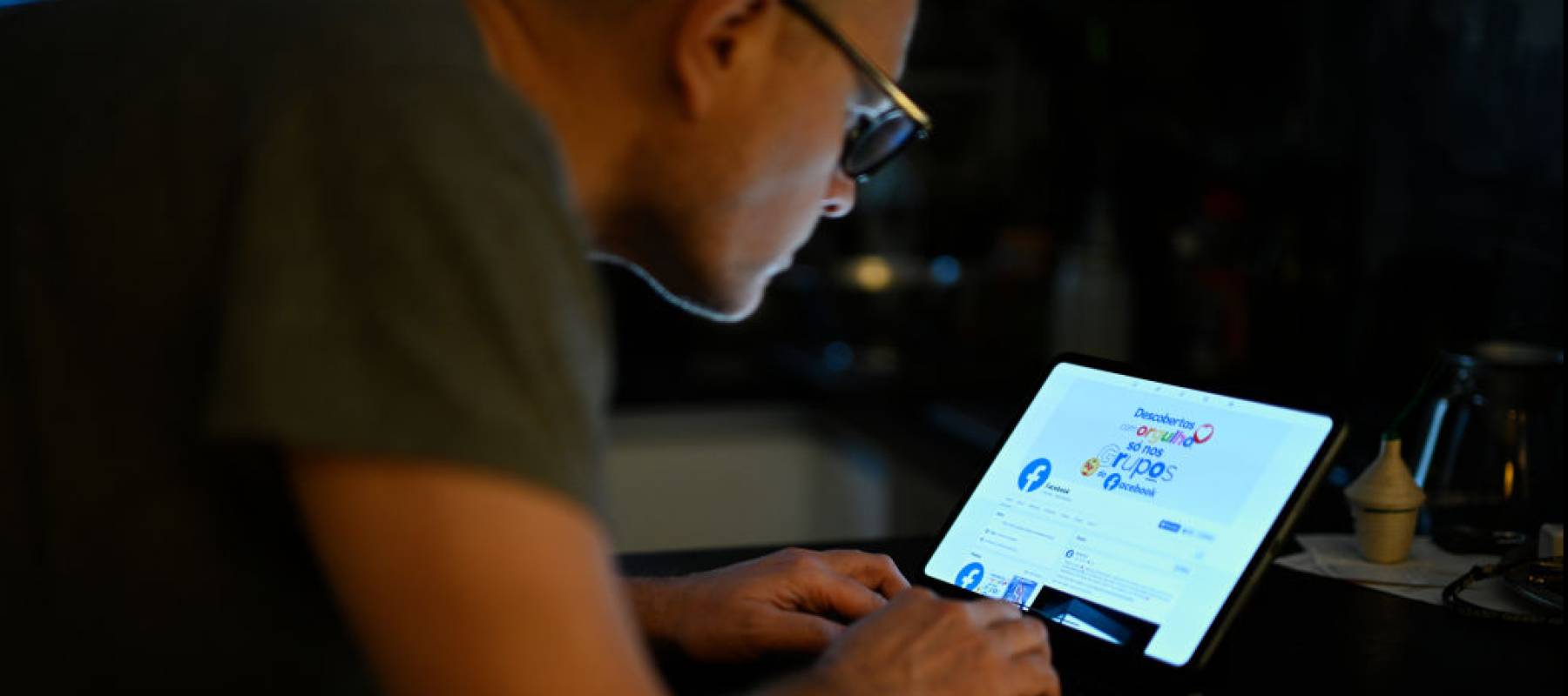 Man looking at FB on screen