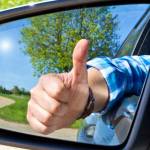 Car driver with thumb up