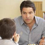 Young family enjoying a meal at home and having a conversation