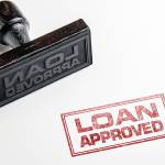 Rubber stamping that says 'Loan Approved'.