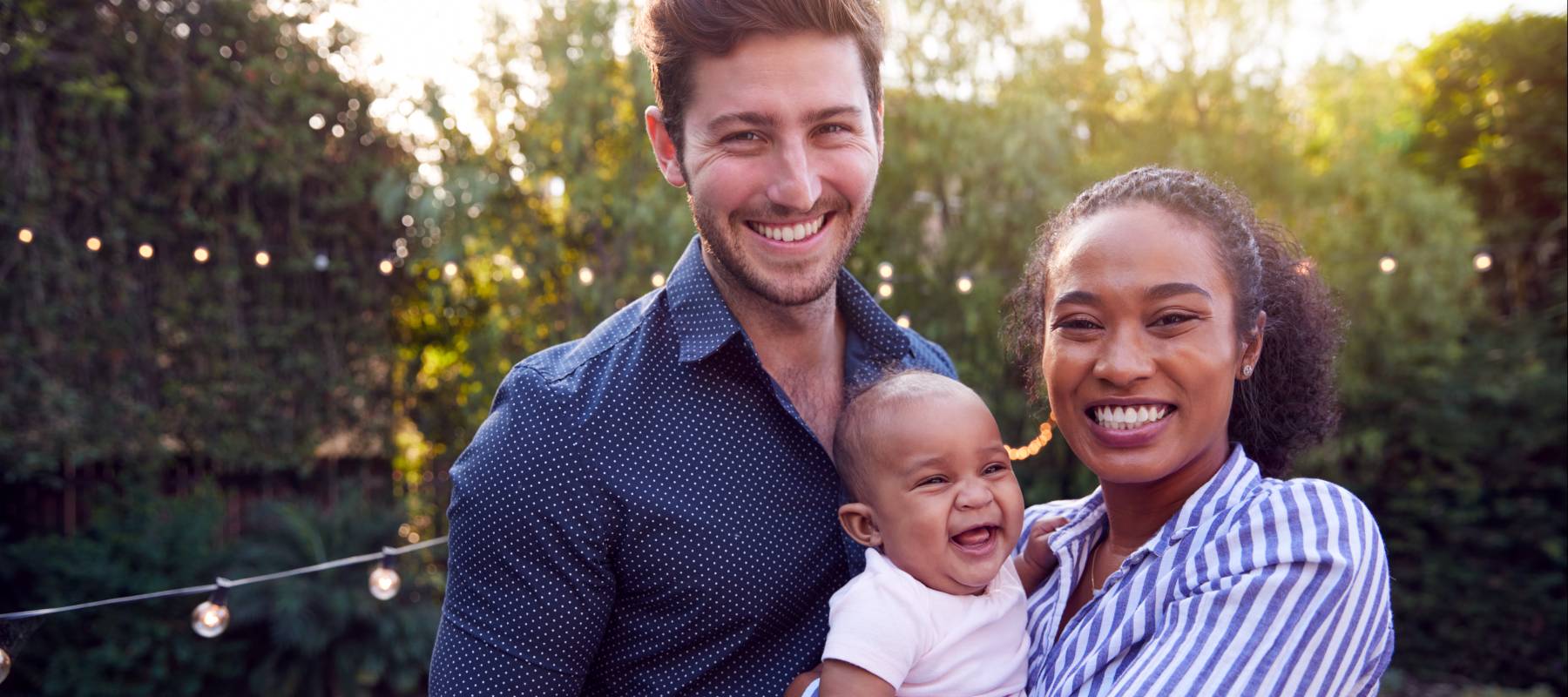 Happy young couple with child.